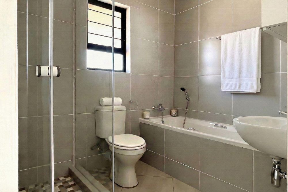 Family bathroom with bath and shower.