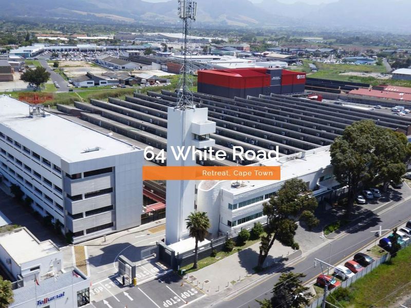 Aerial view of a large industrial property in Retreat, Cape Town, featuring a multi-story office building, warehouse facilities, and a telecommunications tower.