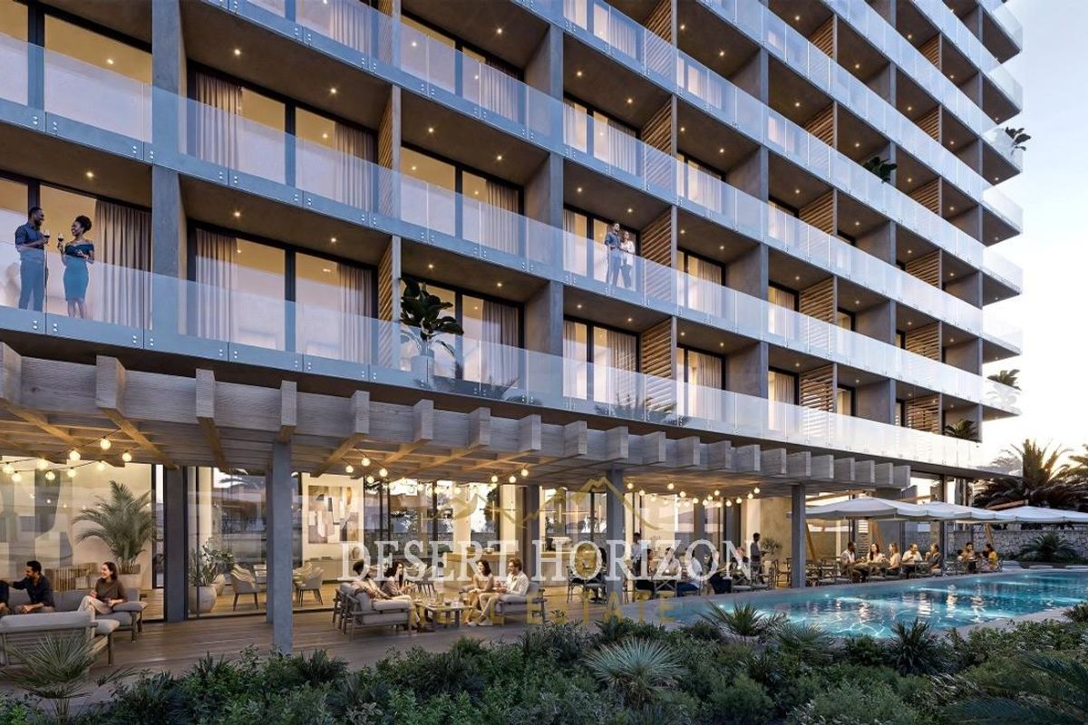Modern hotel exterior featuring a swimming pool, timber pergola, and multi-story building with glass-fronted balconies.