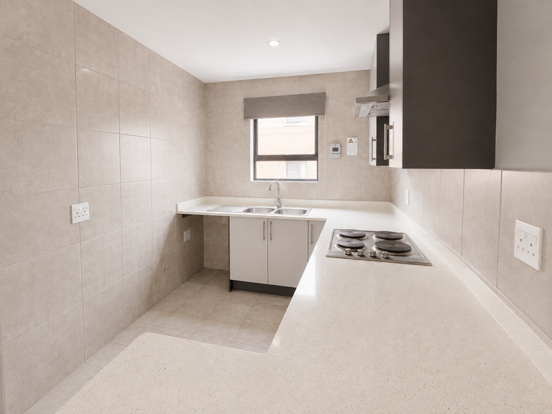 A modern, clean kitchen featuring neutral tiled walls, stone countertops, built-in cabinetry, an electric hob, and a double sink with a window view.