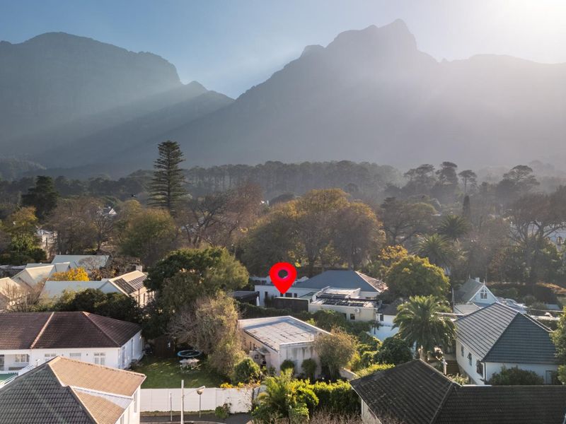 Aerial view of the property nestled in a residential neighborhood with a prominent mountain backdrop.