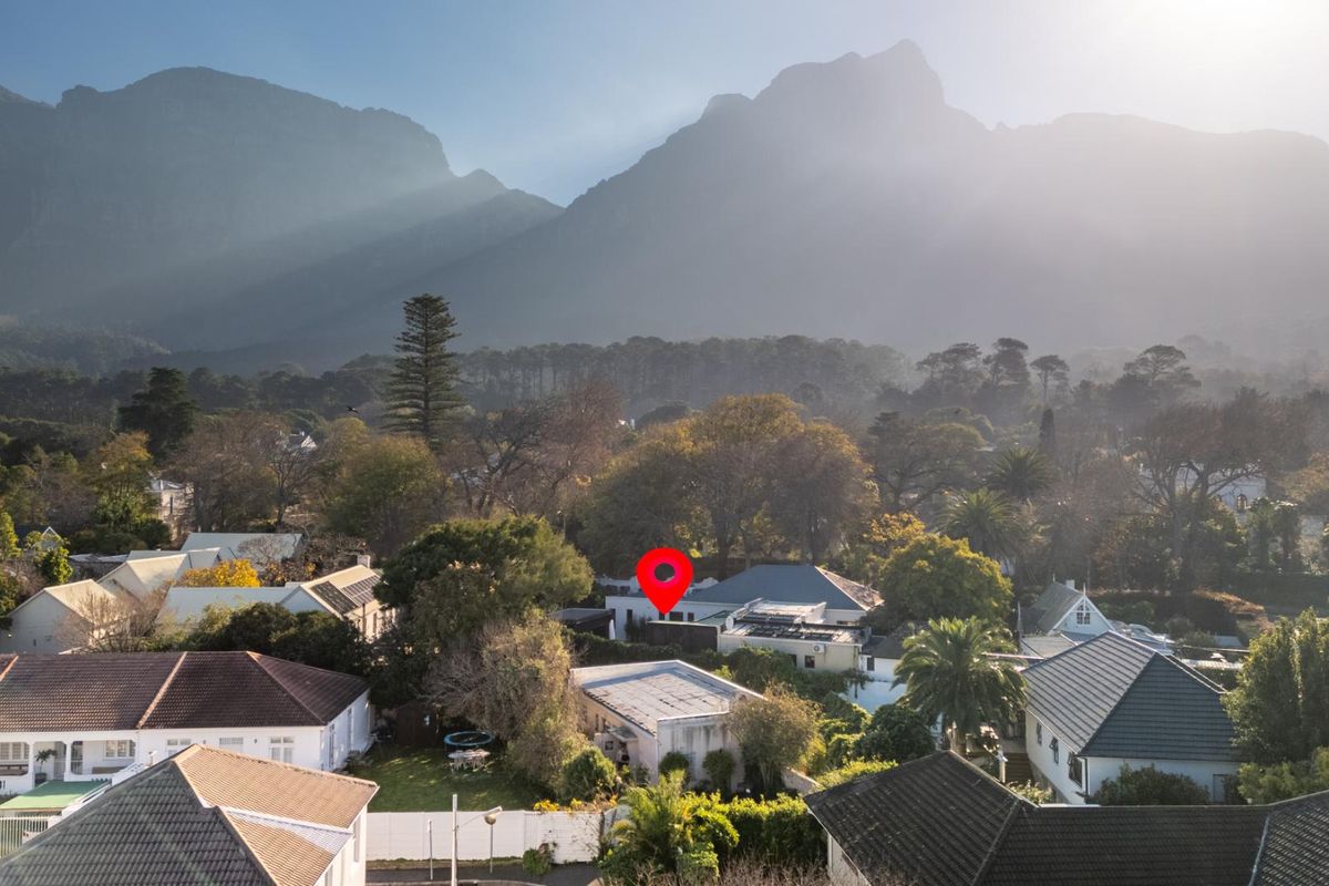 Aerial view of the property nestled in a residential neighborhood with a prominent mountain backdrop.