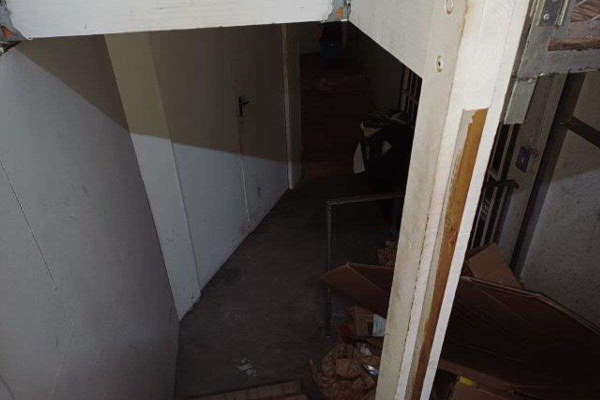 A dimly lit, utilitarian stairwell area showing signs of wear and requiring maintenance.
