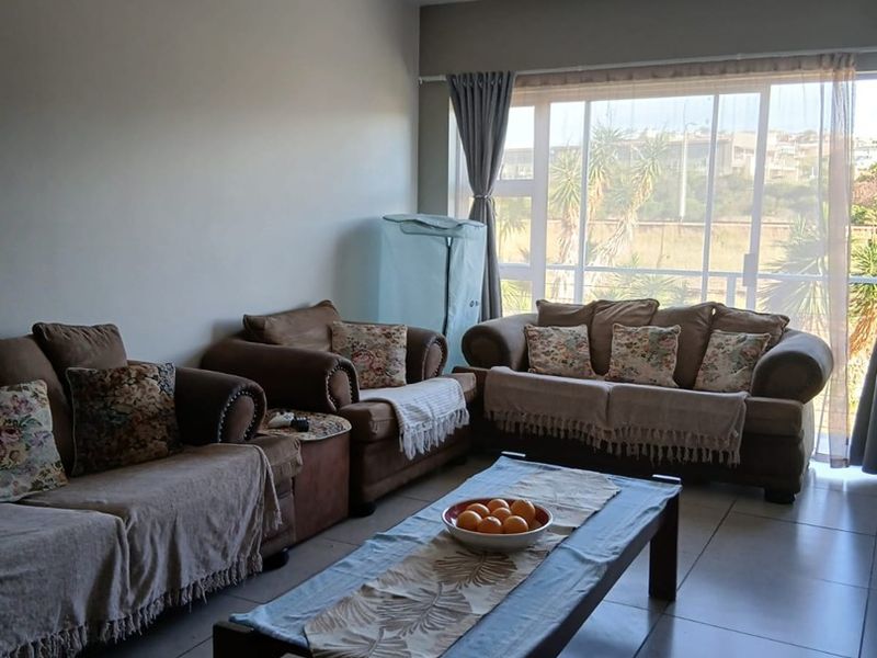 A spacious living room featuring large sliding glass doors that provide ample natural light and access to the exterior.