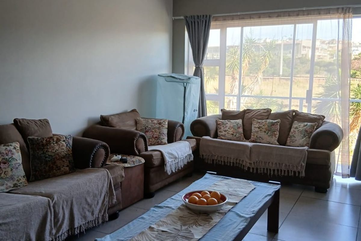 A spacious living room featuring large sliding glass doors that provide ample natural light and access to the exterior.