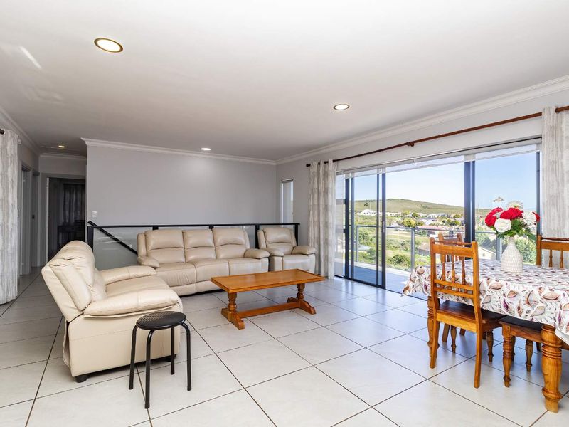 Spacious open-plan living and dining area featuring large sliding glass doors that provide abundant natural light and scenic views.