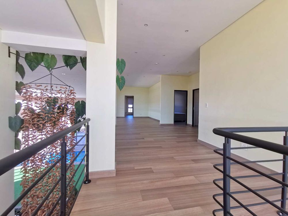 TOP FLOOR LOOKING DOWN TO THE INDOOR GARDEN WITH POOL 