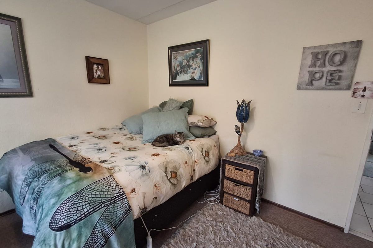A bedroom featuring neutral wall finishes and carpeted flooring, providing a functional and comfortable living space.