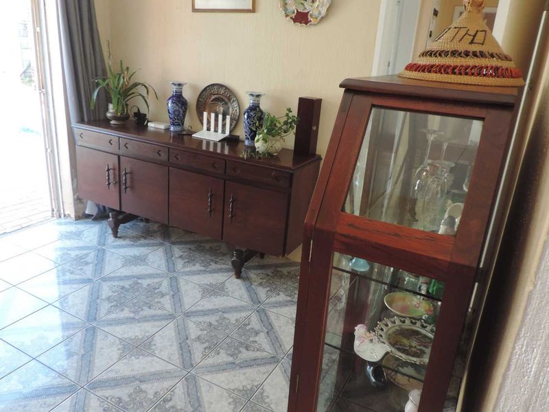 An entrance area featuring patterned ceramic floor tiles and direct access to the exterior.