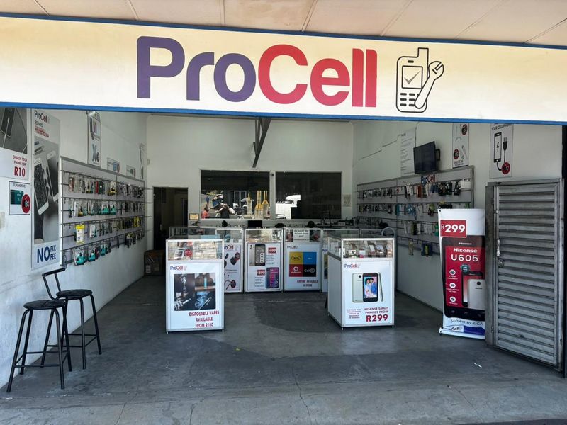 A retail storefront interior featuring fixed display counters and wall-mounted shelving for mobile accessories and repair services.
