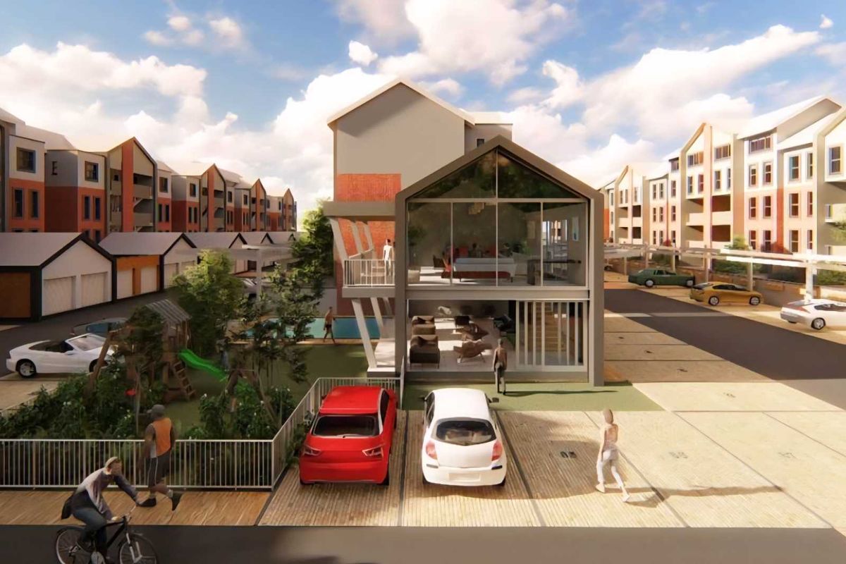 An aerial perspective of a modern apartment complex featuring contemporary architectural design, paved parking areas, and landscaped communal spaces.