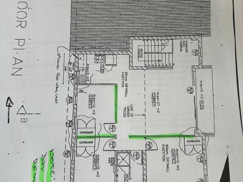 A first-floor architectural plan showing office layout, including partition walls, staircase, and built-in cupboard placements.