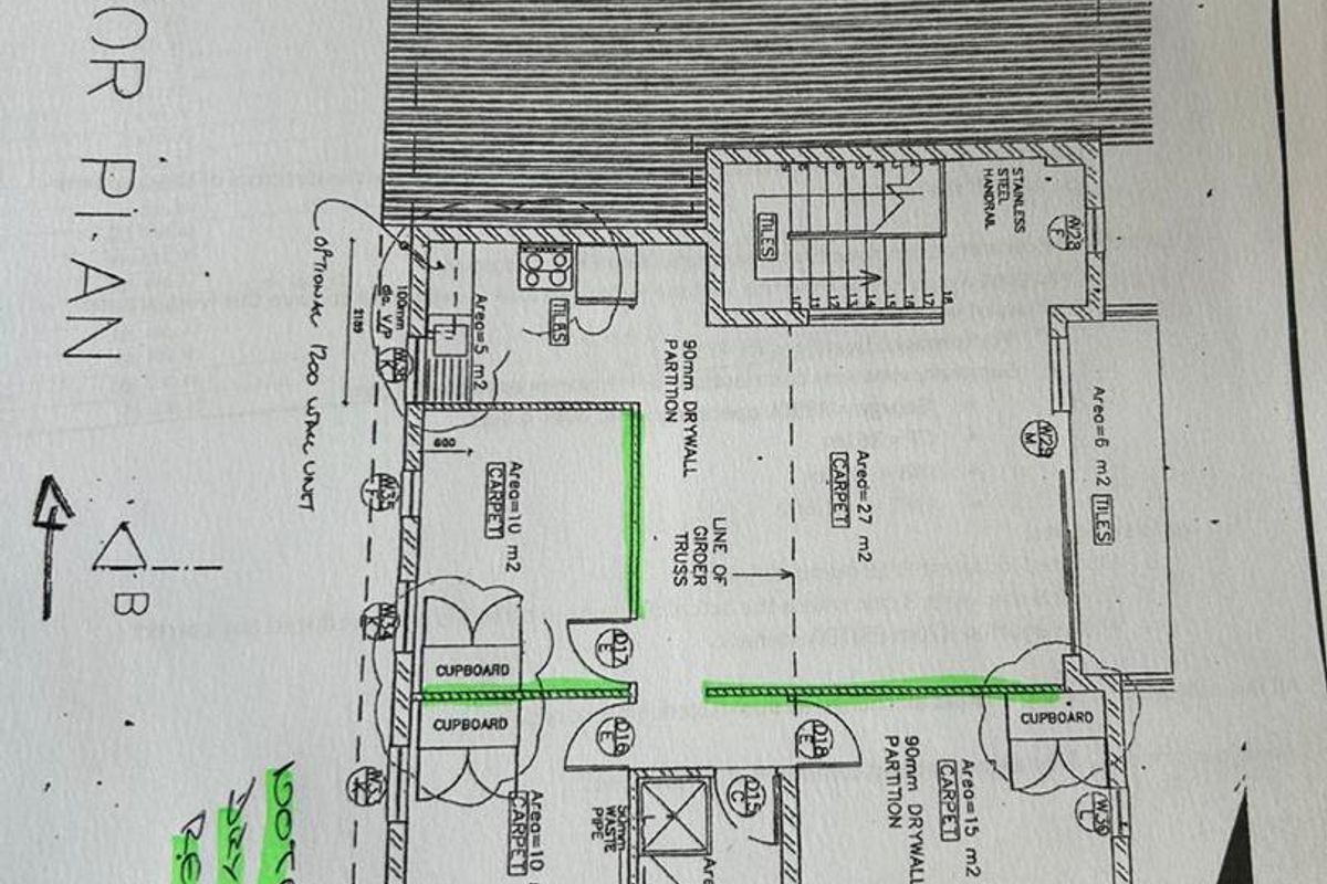 A first-floor architectural plan showing office layout, including partition walls, staircase, and built-in cupboard placements.