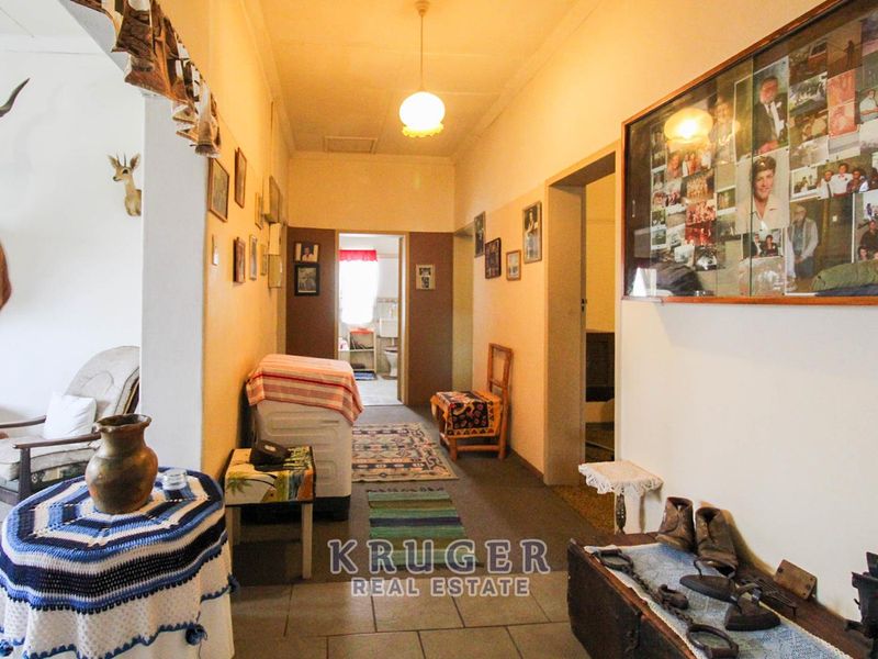 A functional hallway with tiled flooring and pendant lighting, providing access to multiple rooms within the home.