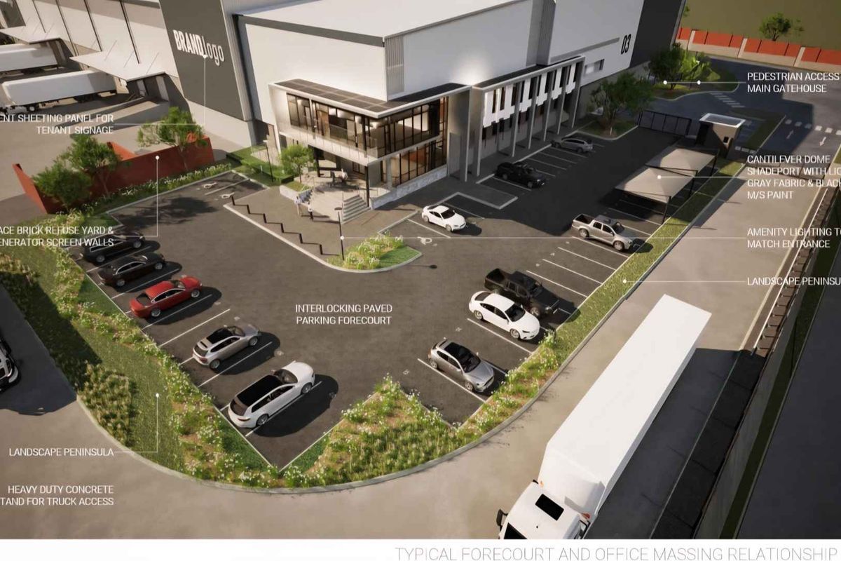 Aerial view of an industrial property featuring an interlocking paved parking forecourt, heavy-duty concrete truck access, and modern office building facade.