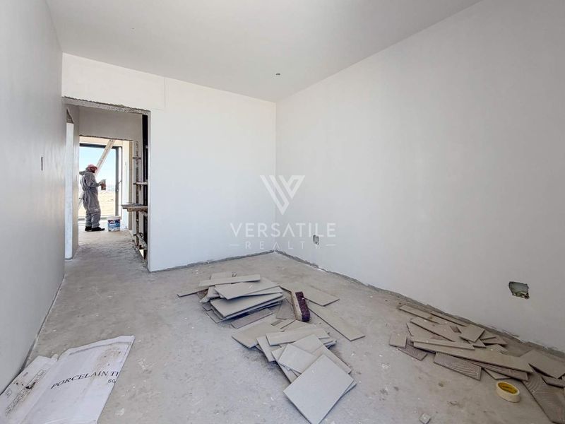 An unfinished bedroom interior currently under construction, featuring bare walls and exposed flooring, awaiting final finishes and installation.