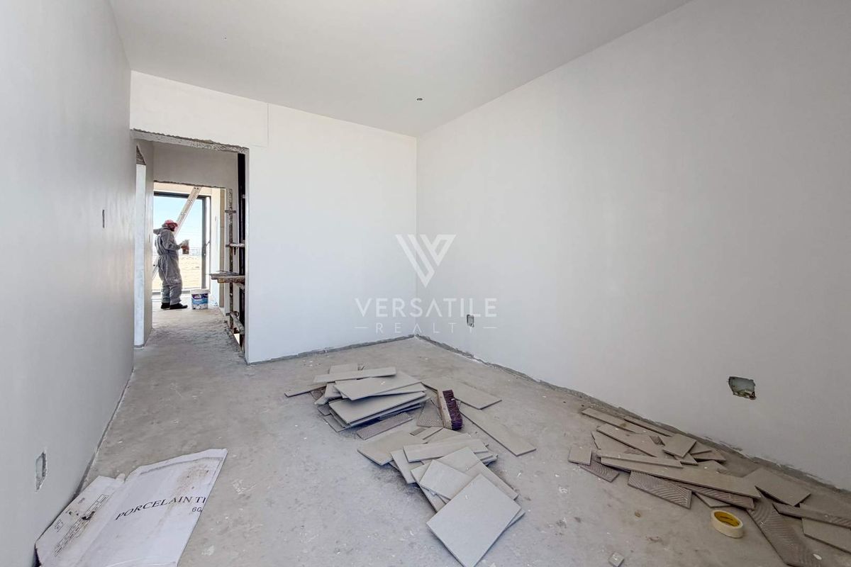 An unfinished bedroom interior currently under construction, featuring bare walls and exposed flooring, awaiting final finishes and installation.