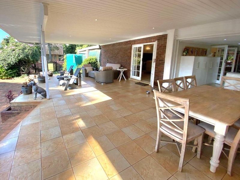 Spacious covered patio featuring tiled flooring, recessed lighting, and direct access to the interior through french doors, ideal for outdoor entertaining.
