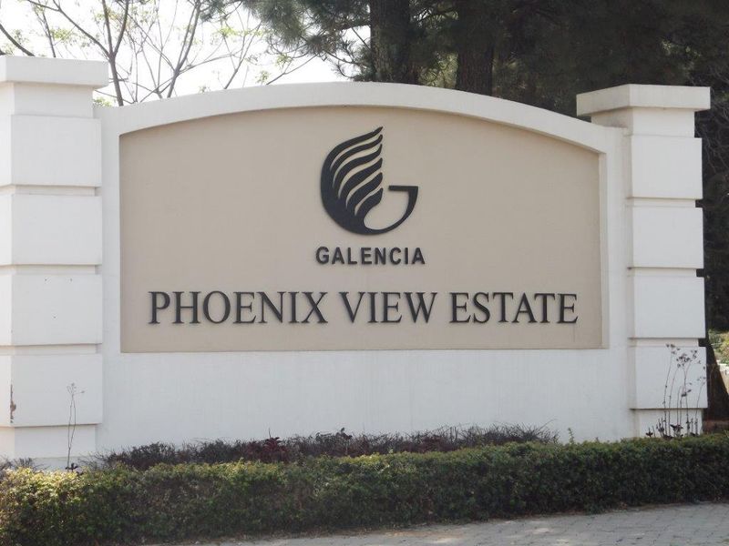 The entrance signage for Phoenix View Estate, featuring a clean masonry structure and well-maintained landscaping.