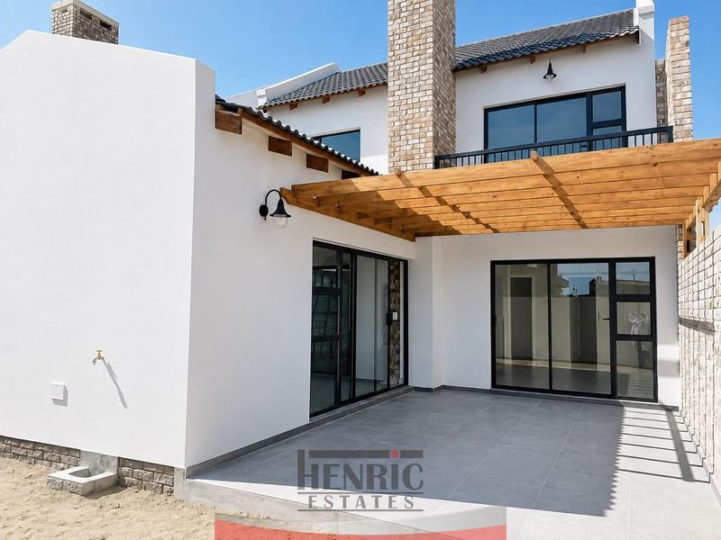 A modern covered patio featuring a timber pergola, tiled flooring, and large sliding glass doors providing seamless indoor-outdoor flow.