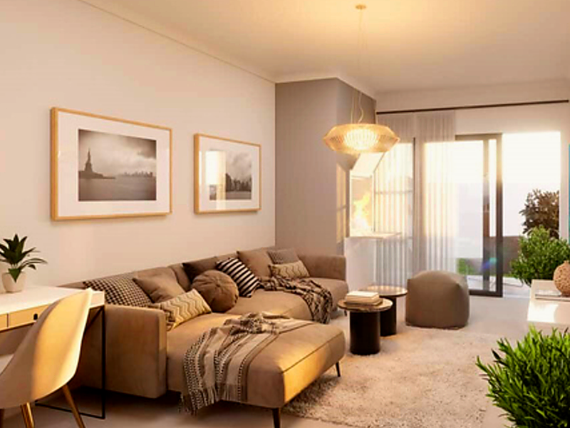 A well-lit living room featuring a sliding glass door leading to an outdoor area, complemented by modern pendant lighting and neutral finishes.