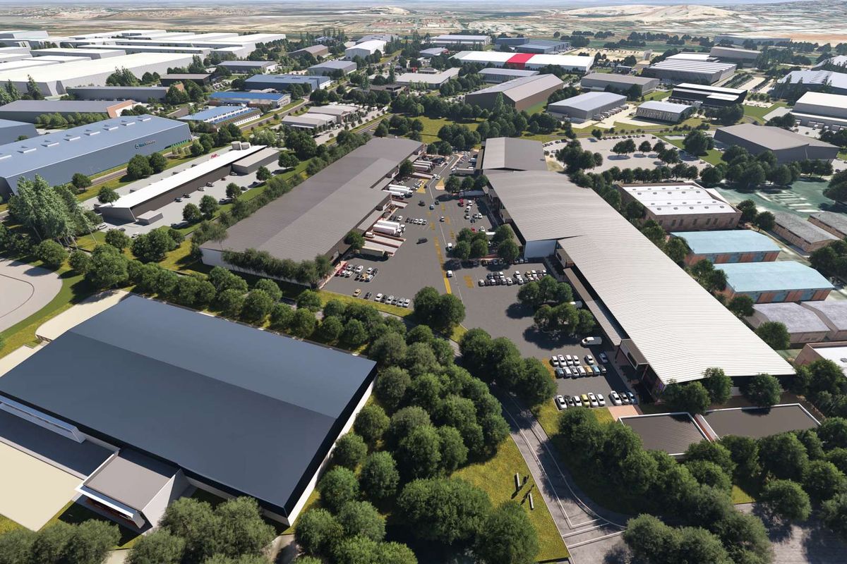 Aerial view of a large industrial park featuring multiple warehouse buildings, extensive parking areas, and landscaped surroundings.