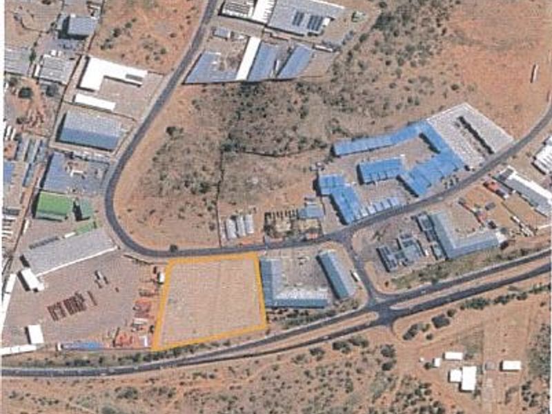 Aerial view of a vacant commercial land plot highlighted in yellow, situated within an established industrial or commercial precinct.