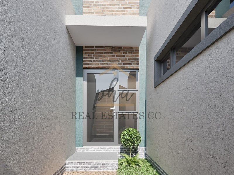 Modern townhouse entrance featuring a textured render facade, brick accents, and a contemporary glass panel door.