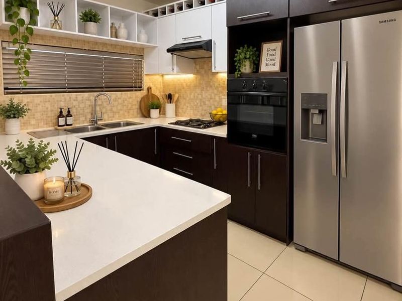 Modern kitchen featuring dark wood and white cabinetry, quartz countertops, integrated appliances, gas hob, and stylish tiled backsplash with ample storage.