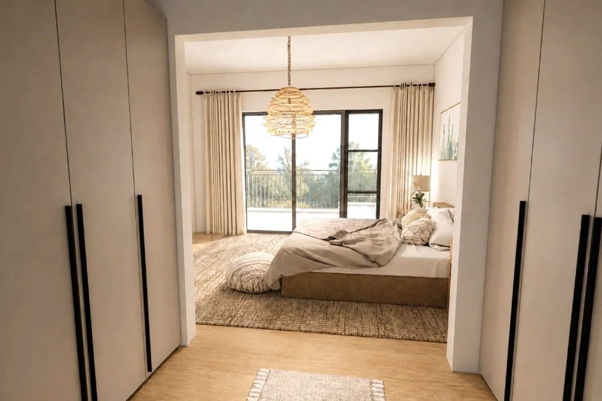 Spacious bedroom featuring built-in wardrobes, timber flooring, and a sliding glass door providing direct access to a private balcony.