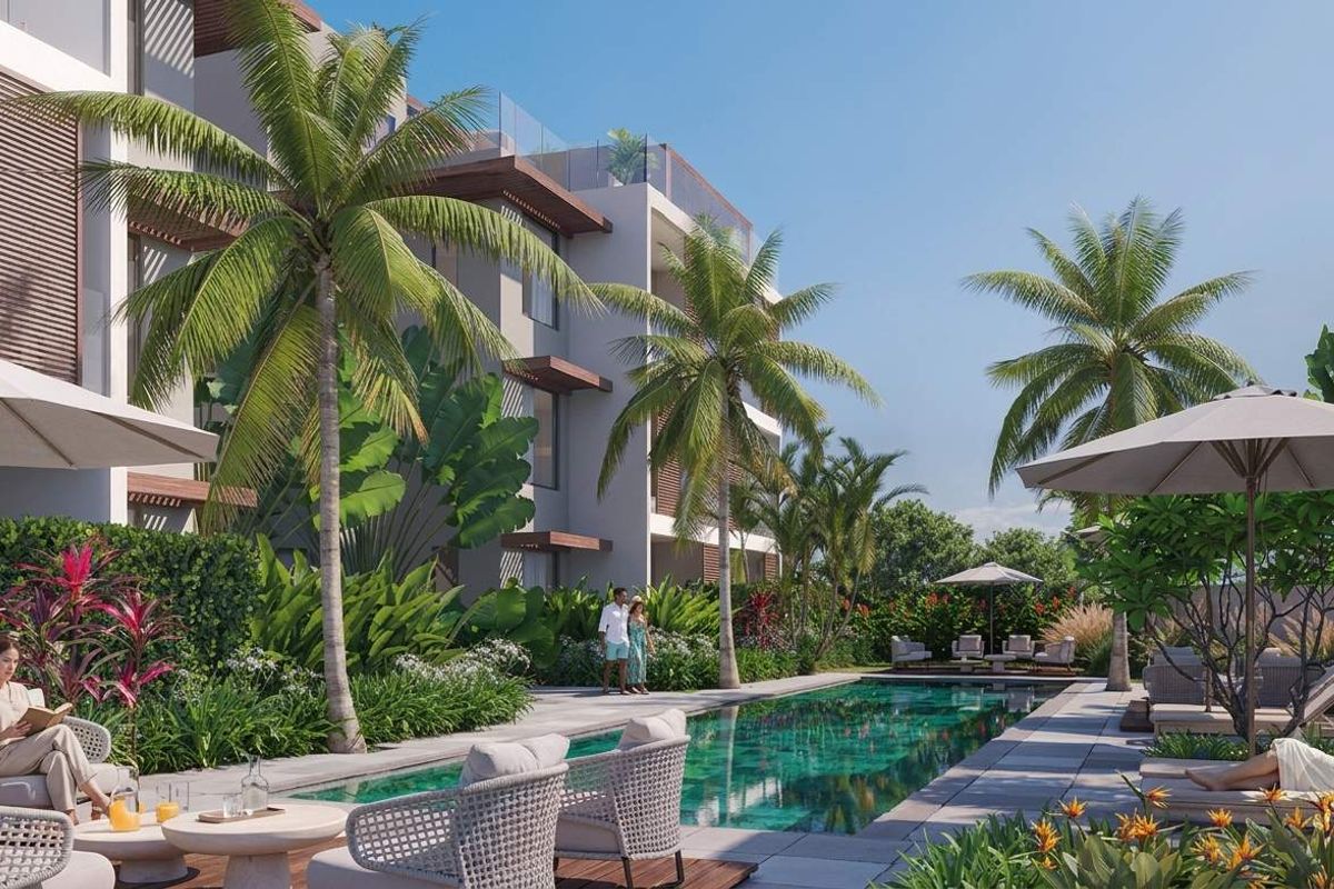 A beautifully landscaped outdoor pool area featuring a modern swimming pool, stone decking, and glass balustrades, set against a contemporary penthouse building.