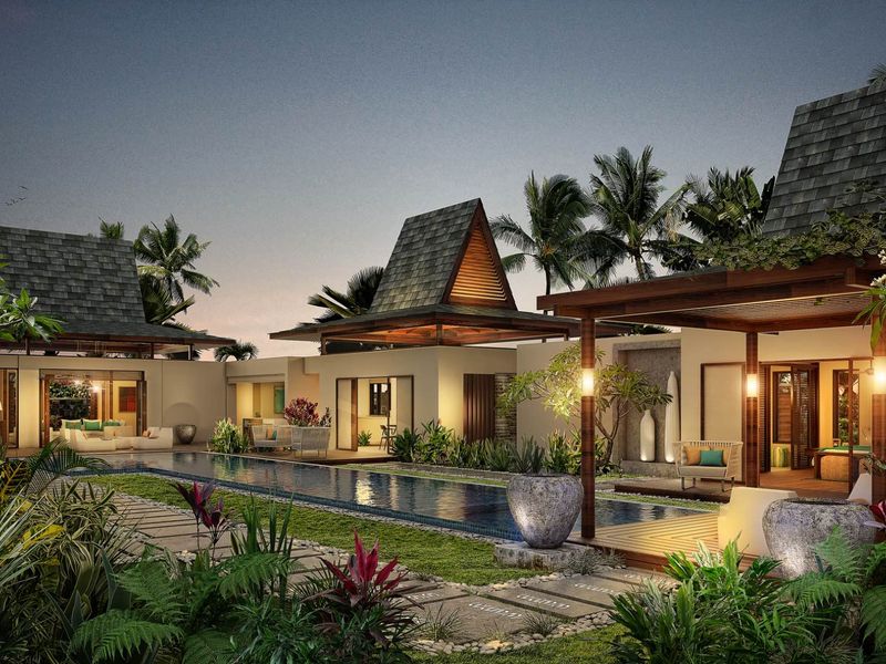 A luxurious outdoor pool area featuring a long swimming pool, timber decking, stone pathways, and beautifully landscaped gardens surrounding the modern villa structures.
