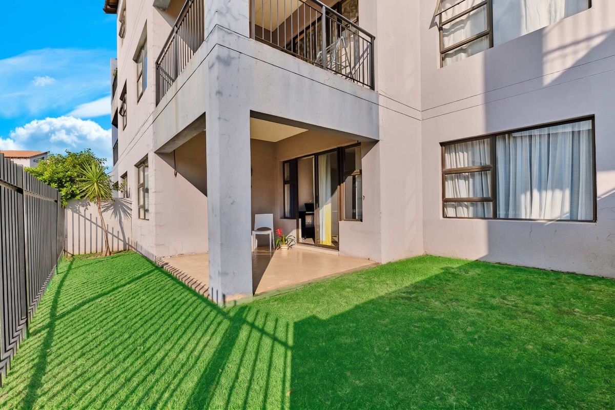 Ground floor apartment featuring a covered patio area with direct access to a private garden space.