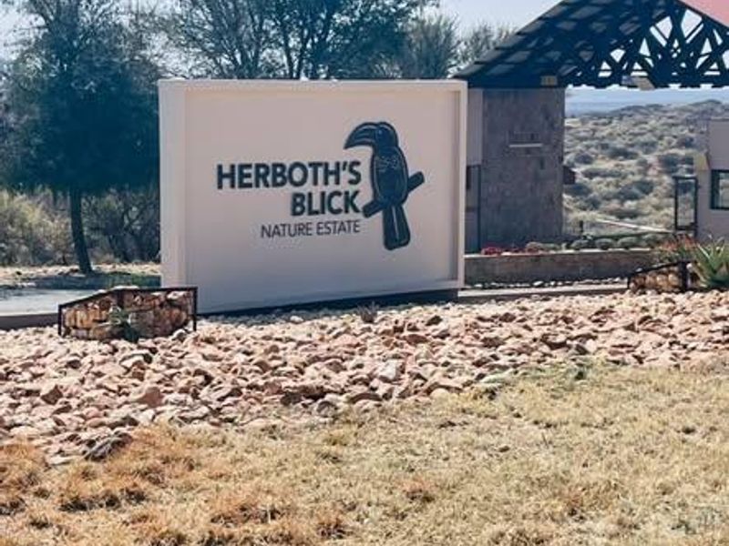 Entrance view of Herboth's Blick Nature Estate featuring a prominent estate sign and gated access structure.