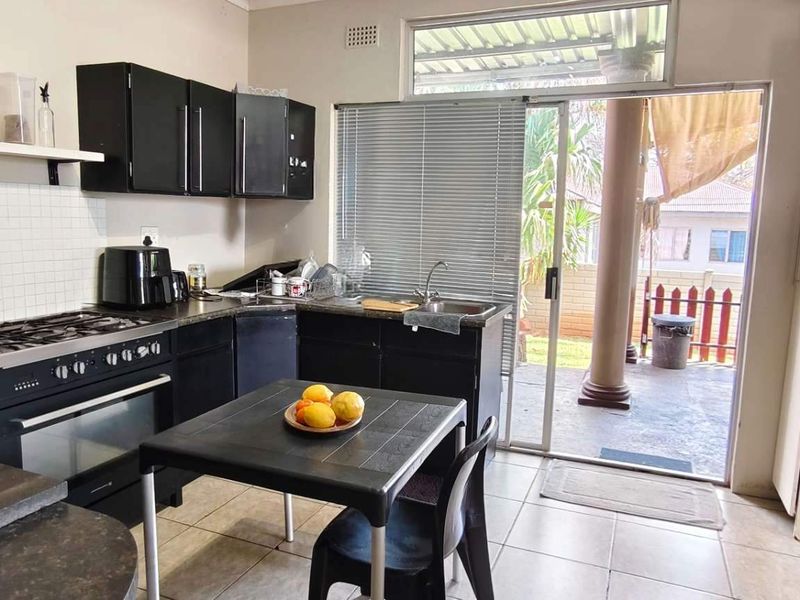 Spacious Family Home with Income-Generating Bachelors Flat on Large Stand - Photo 3