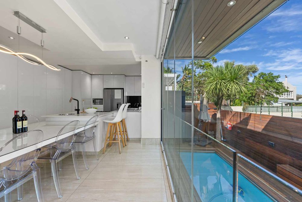 Kitchen, dining and stacking doors open on to the swimming pool