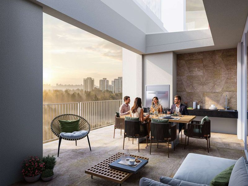 A spacious covered penthouse balcony featuring a built-in outdoor kitchen area, stone-tiled flooring, and panoramic city views.