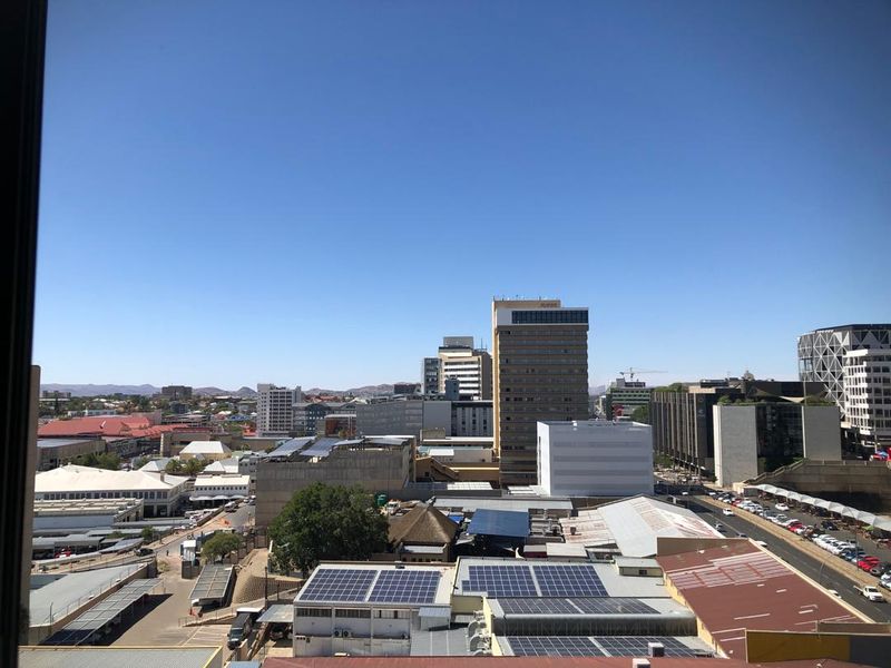 An elevated urban cityscape view looking out over surrounding buildings and infrastructure.