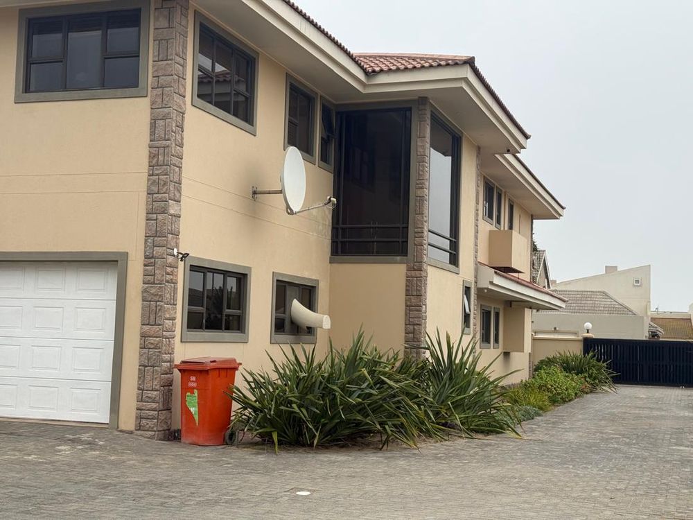 Side view of the house with paved drive way