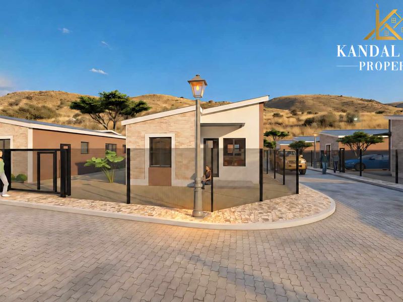 A modern townhouse exterior featuring stone cladding, a skillion roof, and paved driveway access within a residential development.