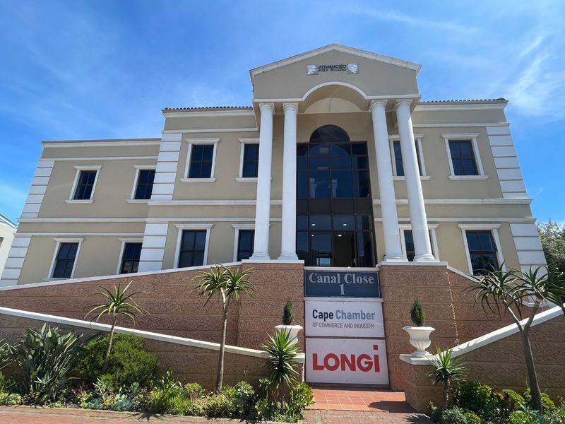 Front elevation of a multi-story commercial office building featuring classical architectural elements, columns, and prominent signage for Canal Close and Cape Chamber.