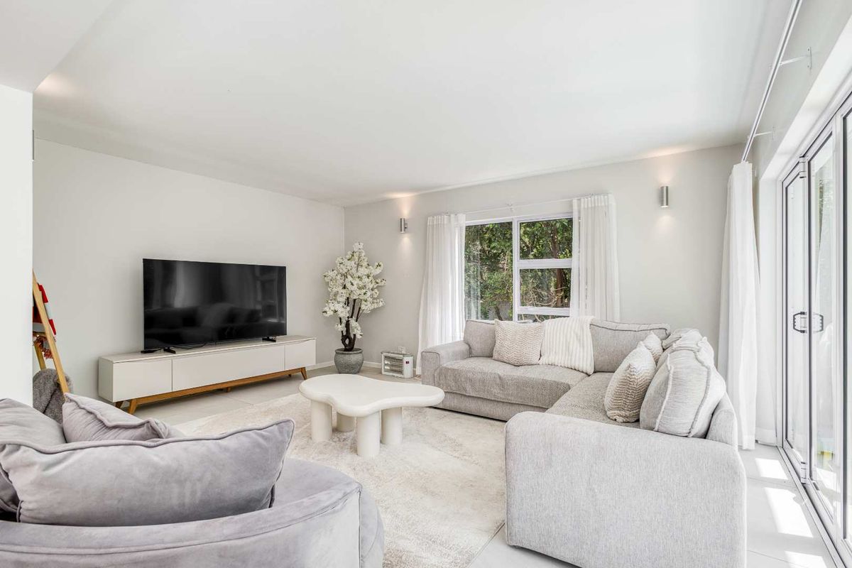 Bright and modern living room featuring large sliding glass doors that provide natural light and access to the outdoor area.