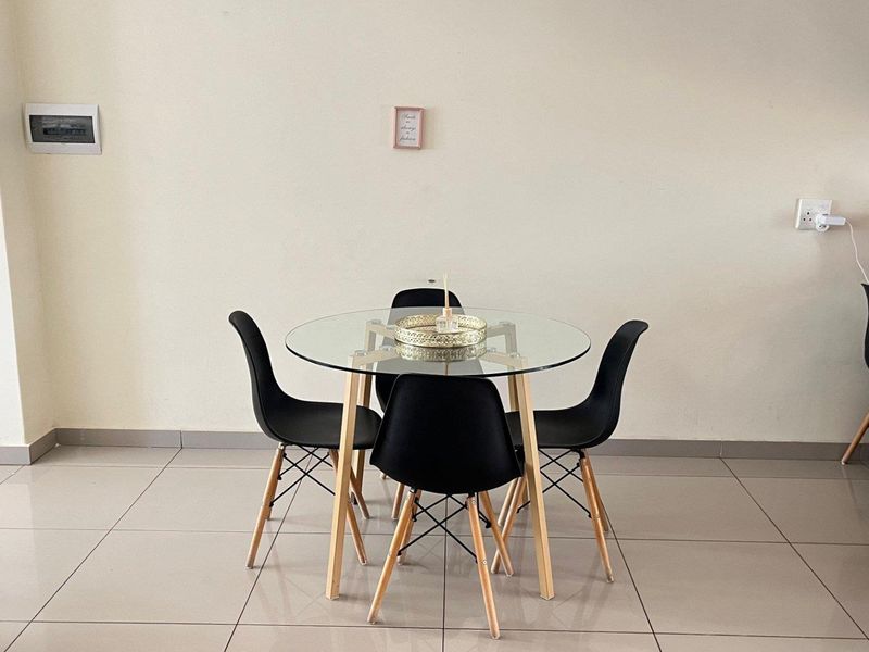 A simple dining area featuring neutral tiled flooring and clean wall finishes, providing a functional space for casual meals.