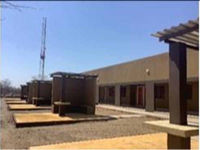 A series of outdoor covered patio areas featuring concrete structures and built-in seating, suitable for farm-style outdoor entertainment.