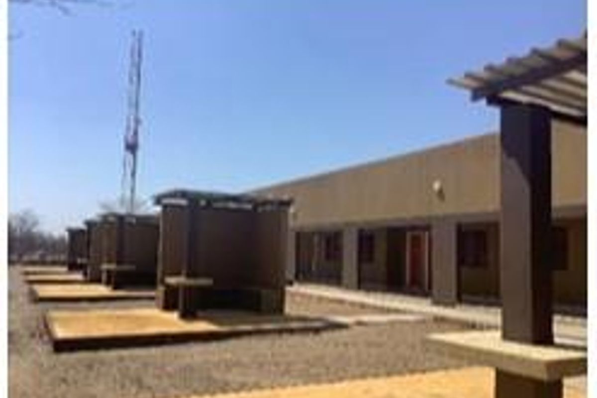A series of outdoor covered patio areas featuring concrete structures and built-in seating, suitable for farm-style outdoor entertainment.