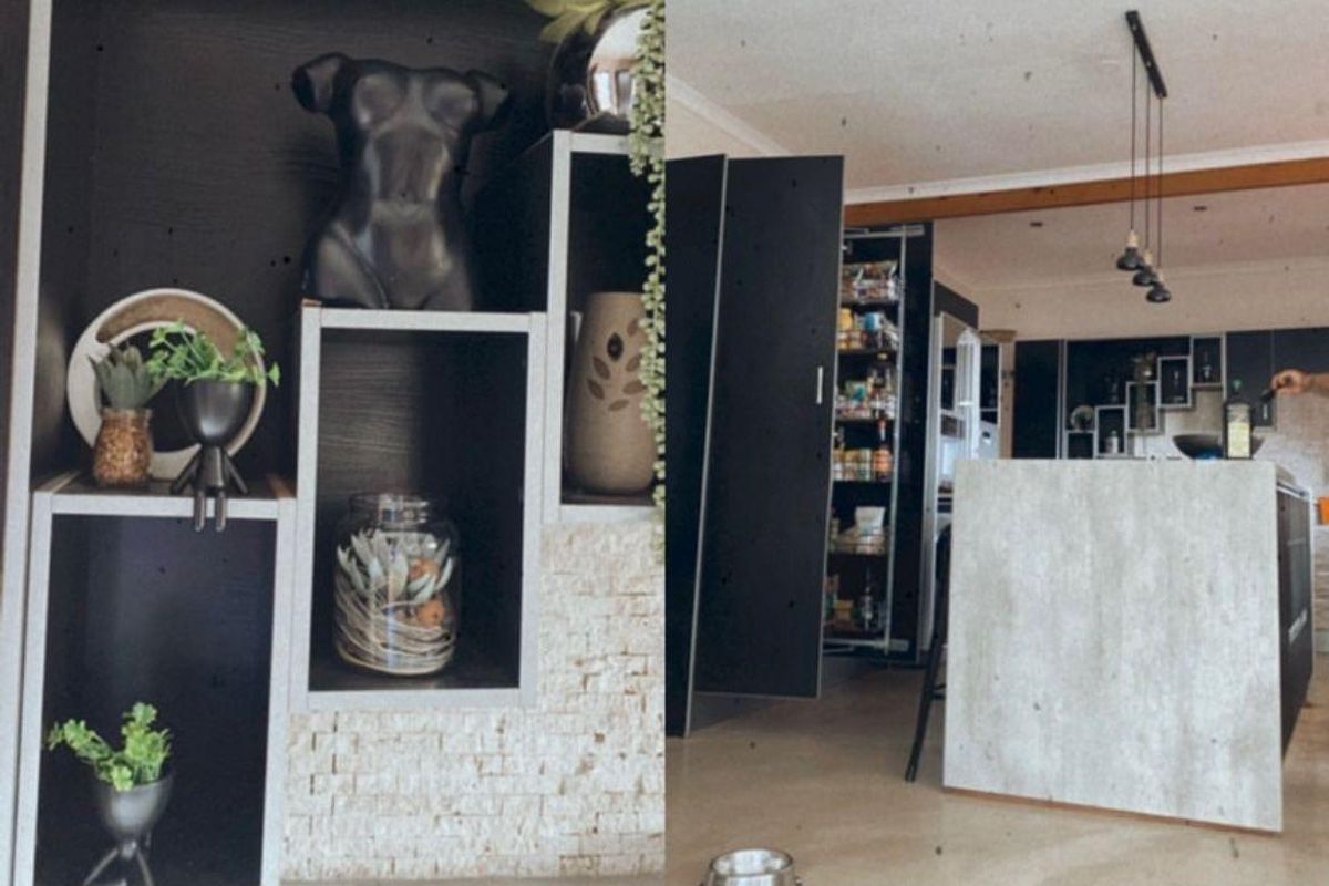 A modern kitchen featuring dark cabinetry, a stone-clad feature wall, and a pantry cupboard with integrated lighting.