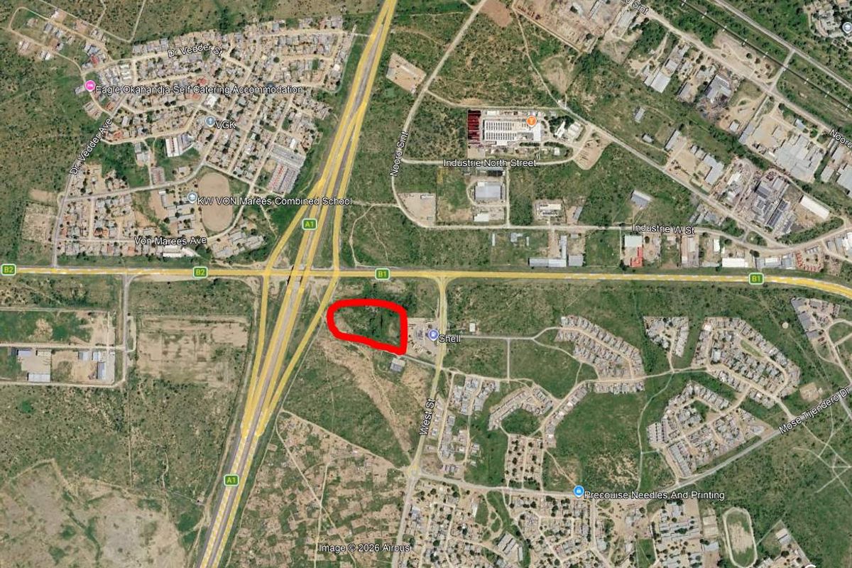 Aerial satellite view showing the location of the industrial property plot highlighted in red near the B1 highway intersection.