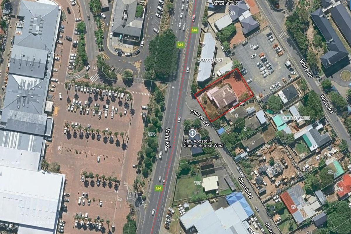Aerial view of the property location showing surrounding infrastructure, road access, and neighboring commercial and residential buildings.