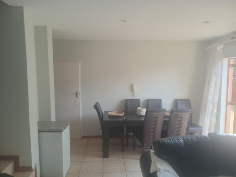 Open plan living and dining area featuring tiled flooring and recessed lighting, providing a functional space for daily living.