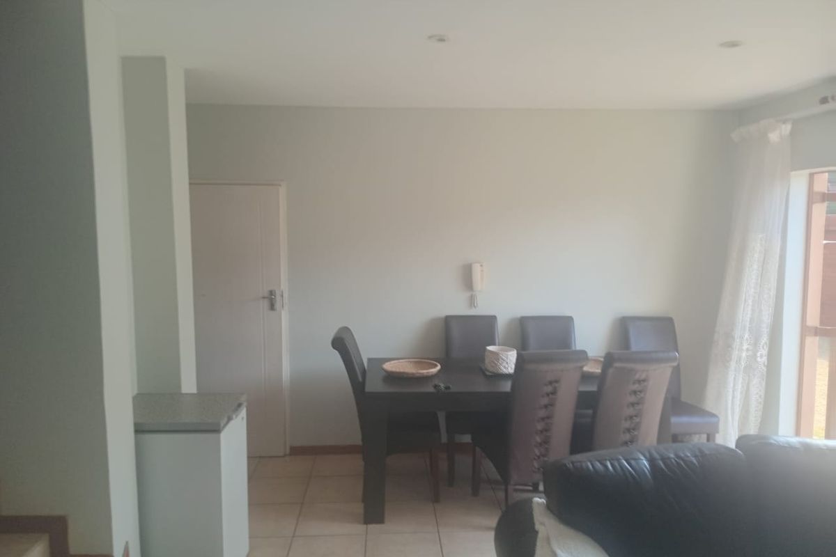 Open plan living and dining area featuring tiled flooring and recessed lighting, providing a functional space for daily living.